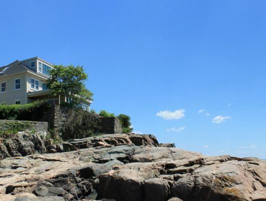 Ultra modern makeover for a traditional oceanfront home in Marblehead by Groom Construction Co.